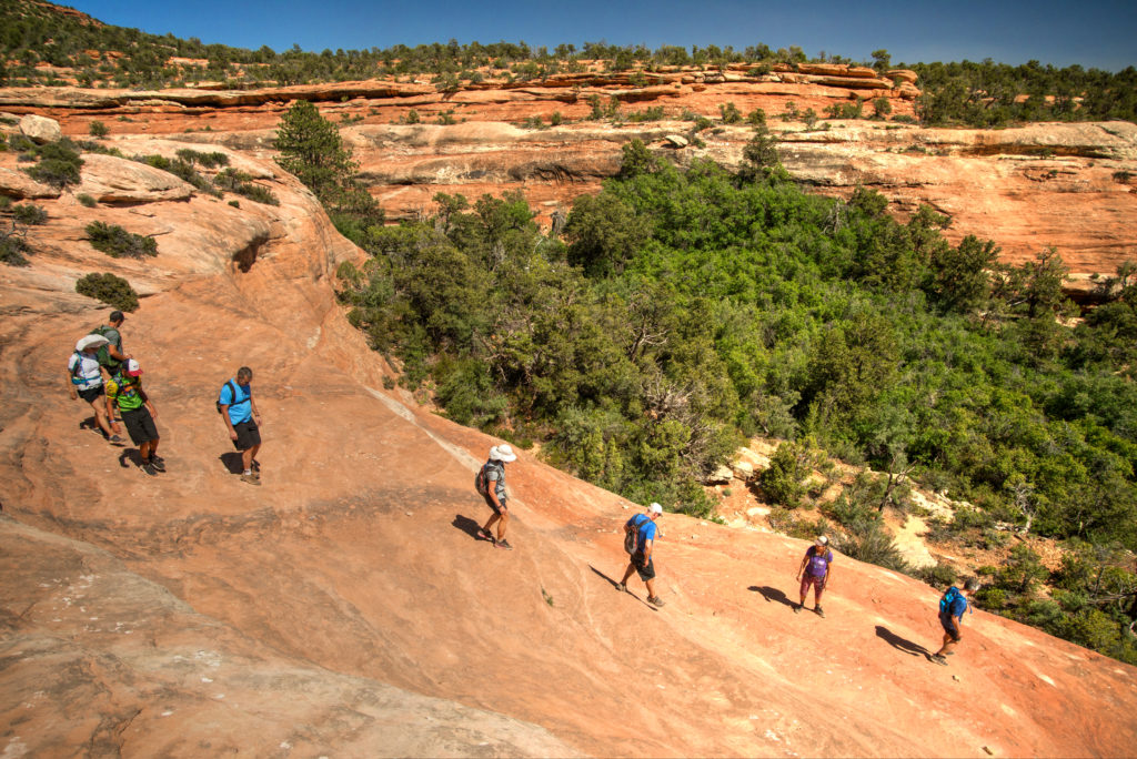 Climate Ride Bears Ears National Monument Bike Tour riders taking a break to enjoy a hike.