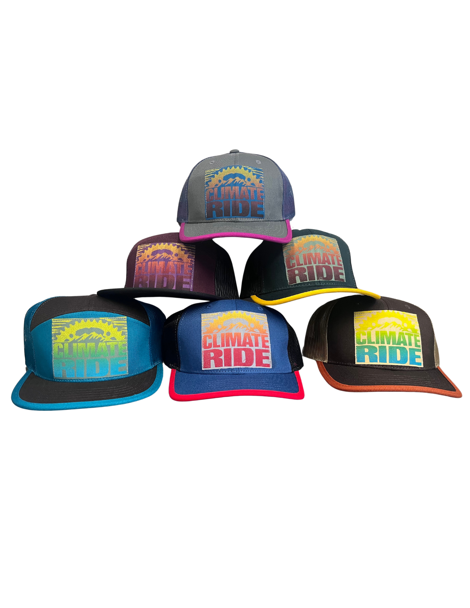 Image of multiple Climate Ride trucker style hats with colorful woodblock print logo designs.