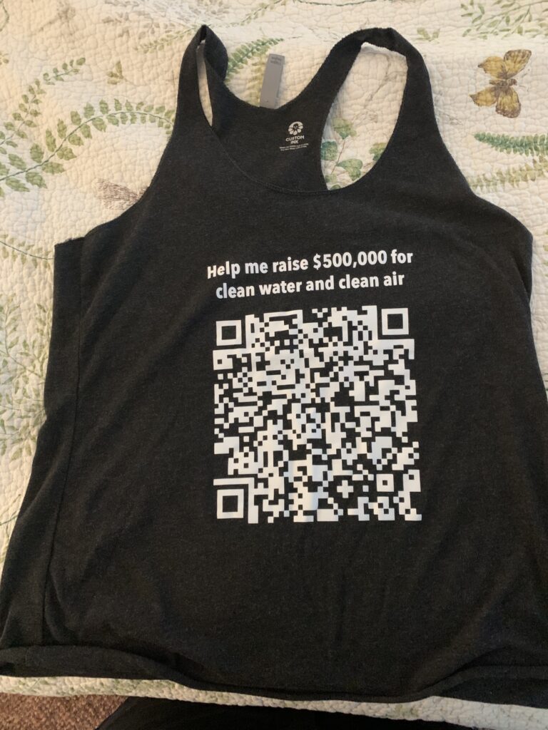 A black shirt with a QR code that Donna made for her cycling fundraiser.