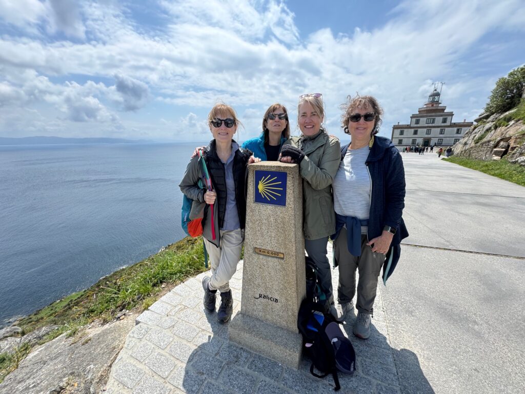 A group of hikers/ walker pausing at a marker on the Camino in Spain. Linda Loewinger