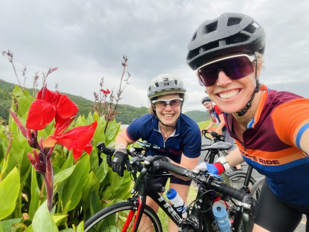 Caeli and Melissa posing with flowers on Japan Ride 