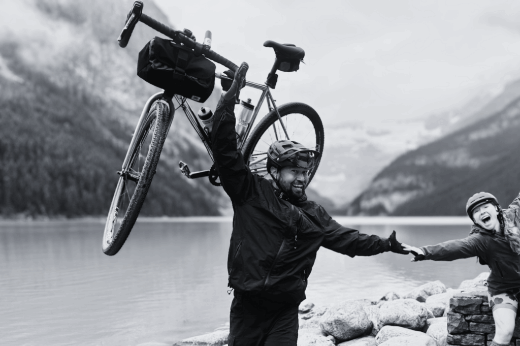 Chris holding a bike aloft at Lake Louise