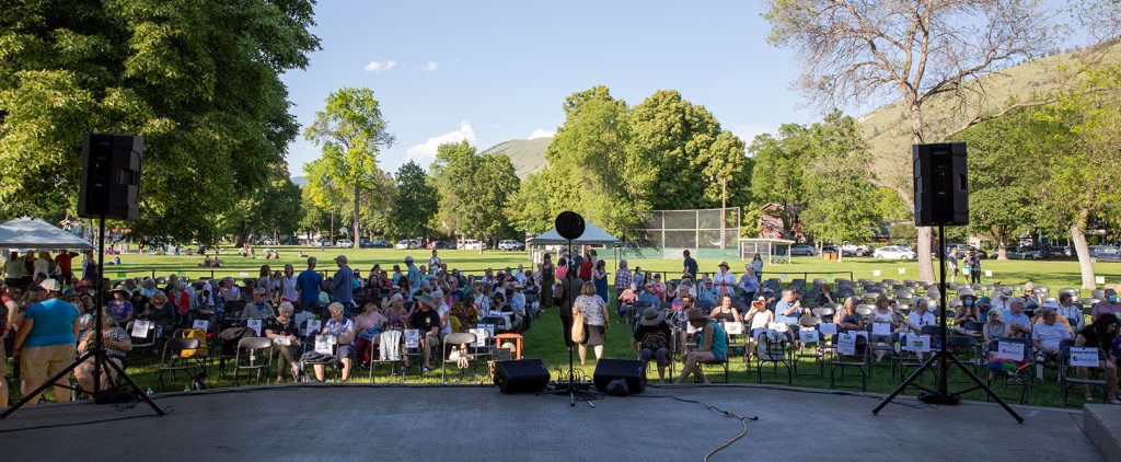 a crowd awaits the beginning of the summer Tell Us Something event
