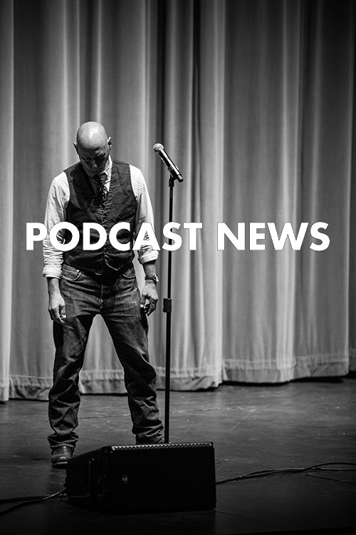 photo credit kmr studios a bald man in front of a microphone looks downward dejectedly
